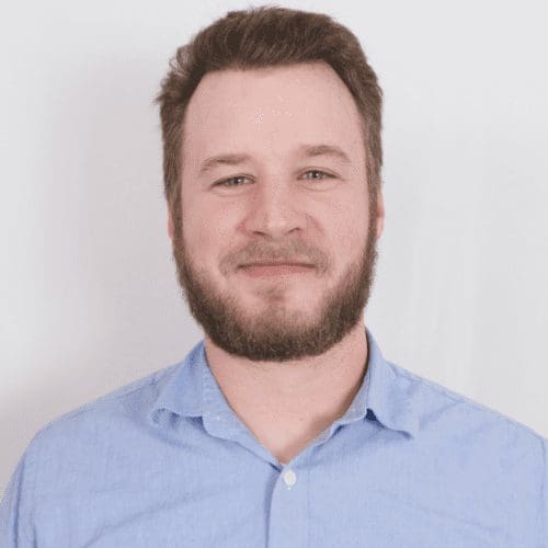 Parker Smith, Project Manager at AIS Commercial Construction, smiling in a blue shirt, representing the team's commitment to quality and client success in commercial construction.