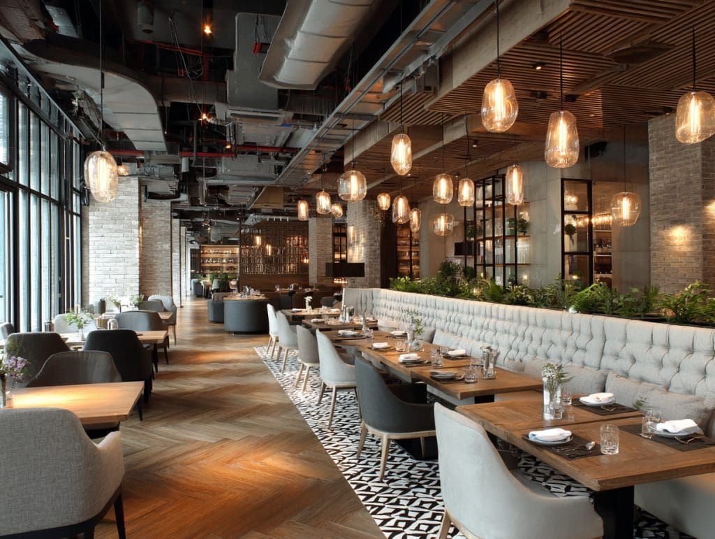 Modern restaurant remodel with elegant seating and lighting.