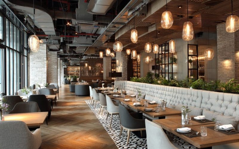 Modern restaurant remodel with elegant seating and lighting.