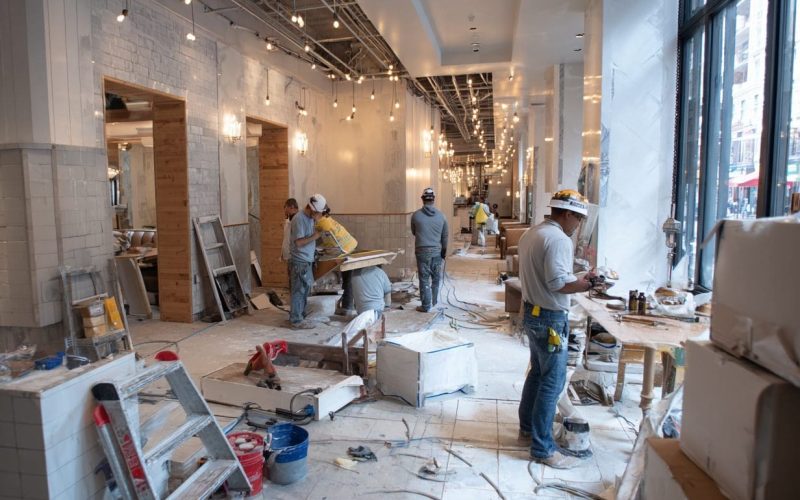 Restaurant remodel in progress with construction workers inside