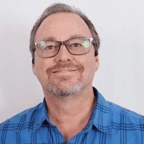 Dave Thaxton, General Superintendent at AIS Commercial Construction, smiling in a blue plaid shirt, showcasing expertise in field operations and project success.