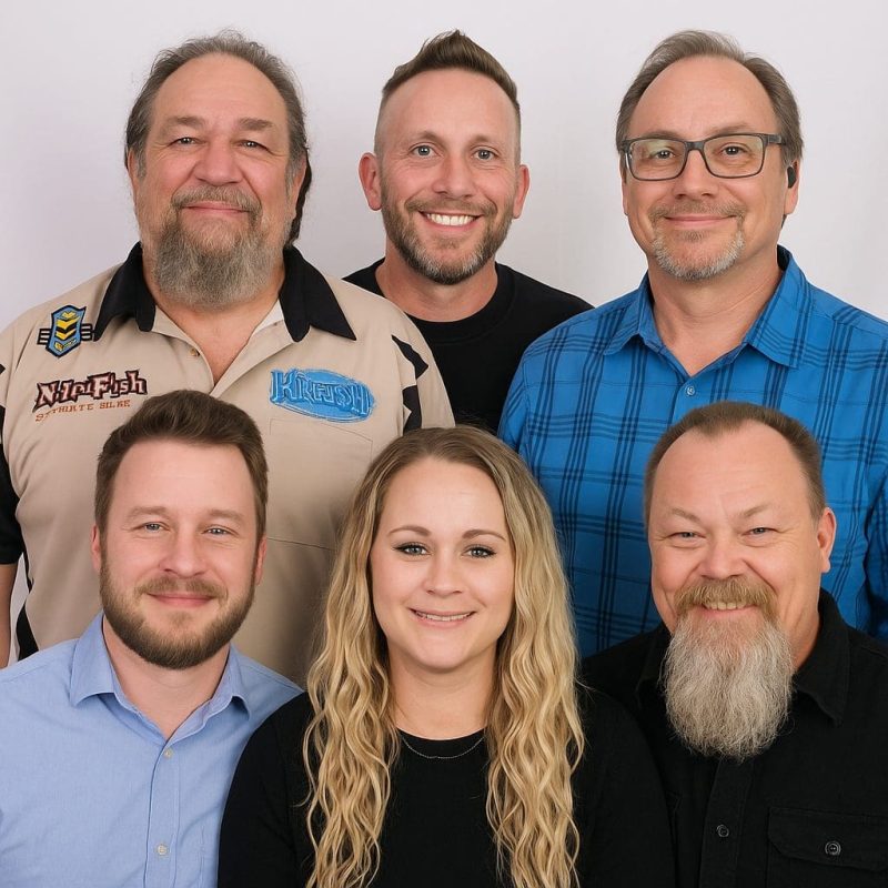 AIS Leadership Team members smiling together in a group photo.